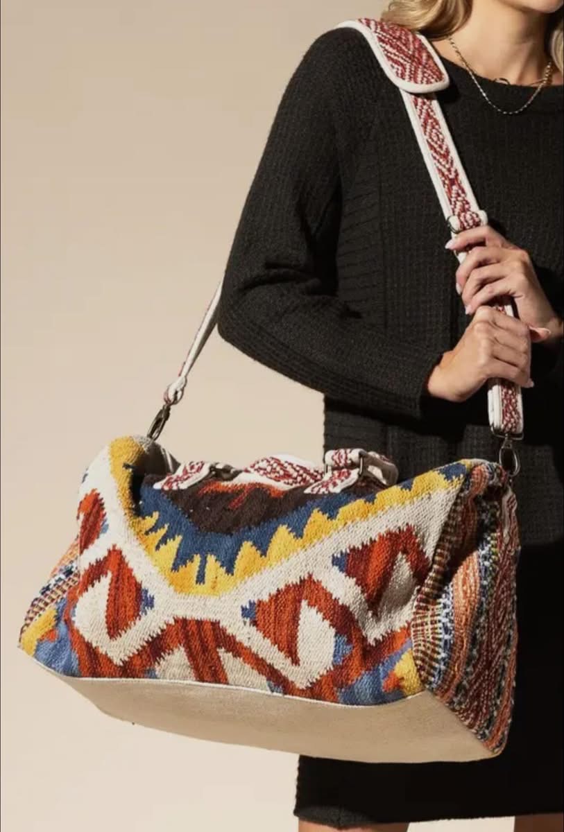 Colorful woven weekender bag with geometric pattern.
